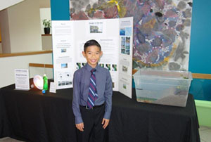 Connor Luong with his science fair project about soil erosion.