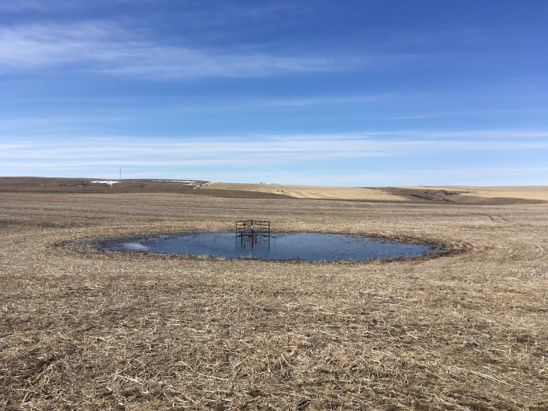 depression in ground filled with water and small equipment