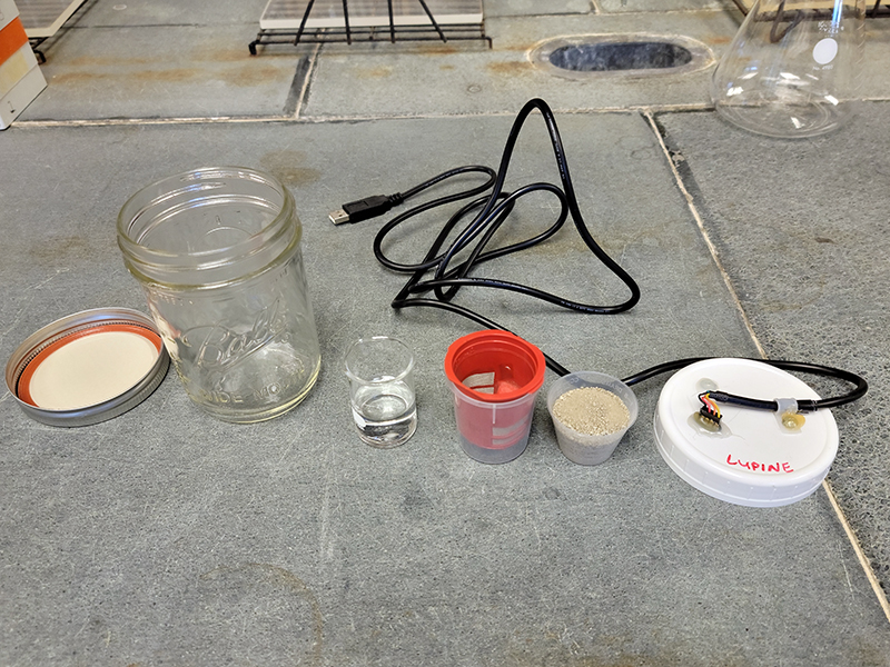 Soil sample, water, container, glass jar, and cover with the infrared analyzer used to measure the carbon dioxide flush.