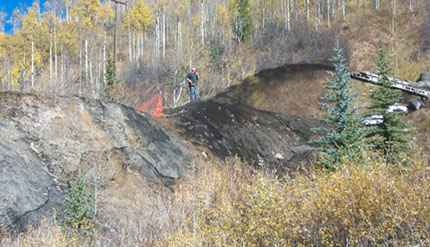 Biochar being distributed over mine-affected slope