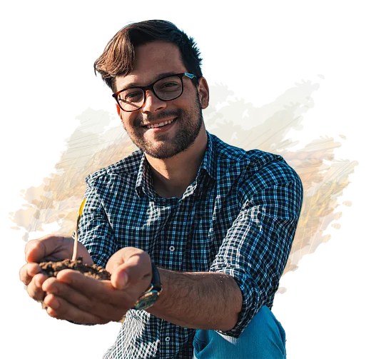 Man with outstretched hands holding soil with small growth